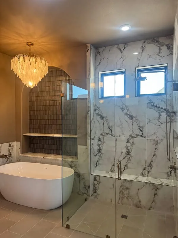 Marble-look shower with glass enclosure