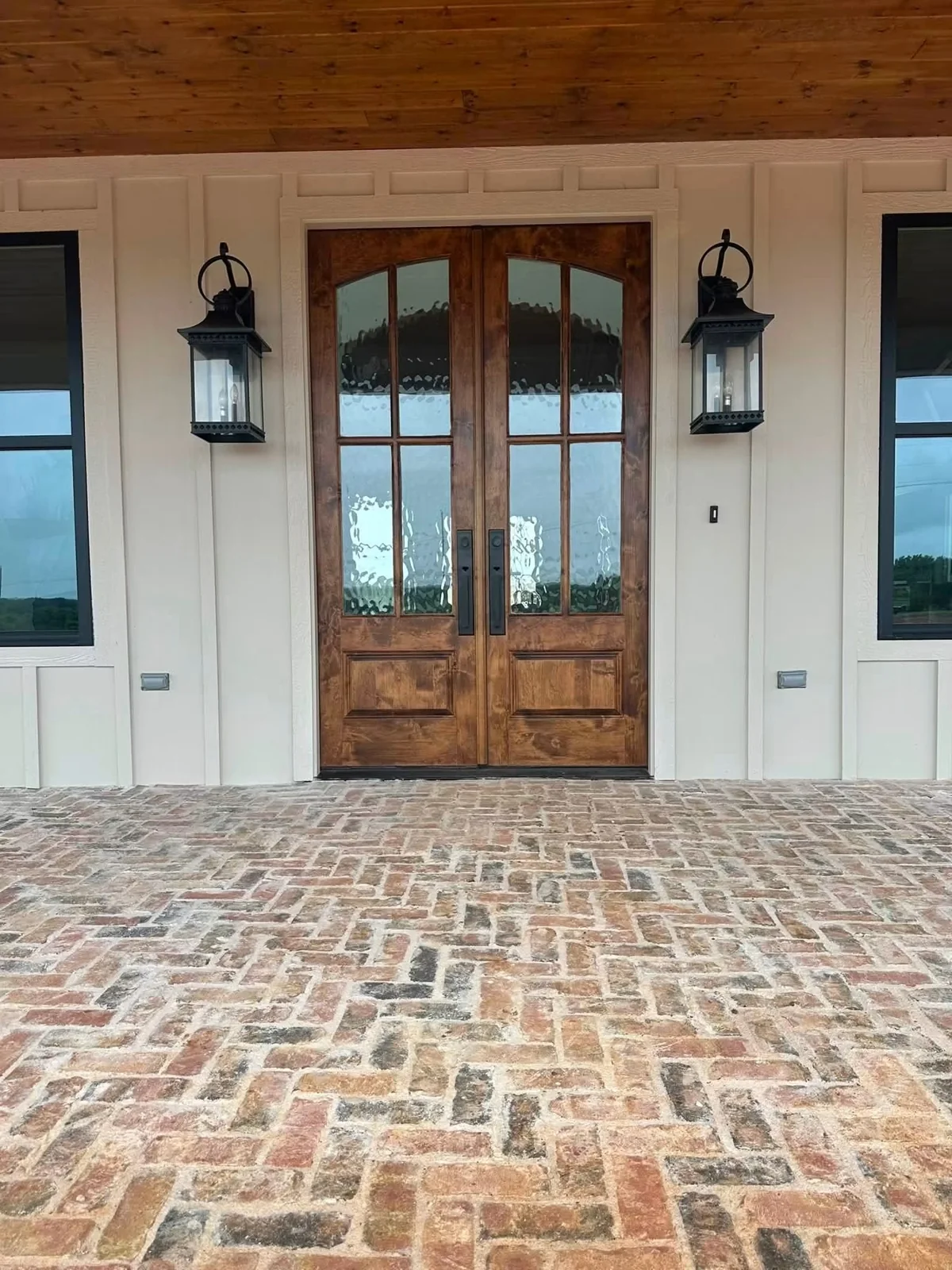Herringbone brick entry and timber double doors