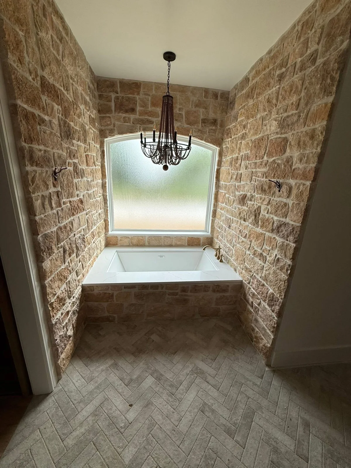 Natural wood cabinets and marble-look stone surfaces